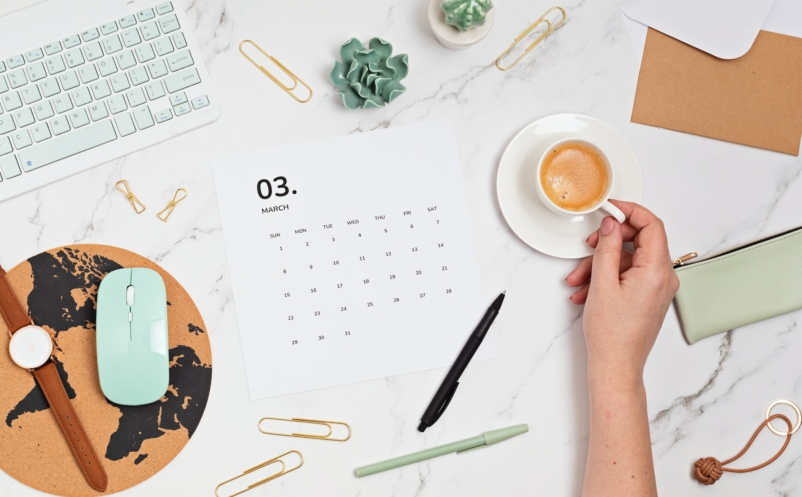 Desktop with calendar for march and office supplies