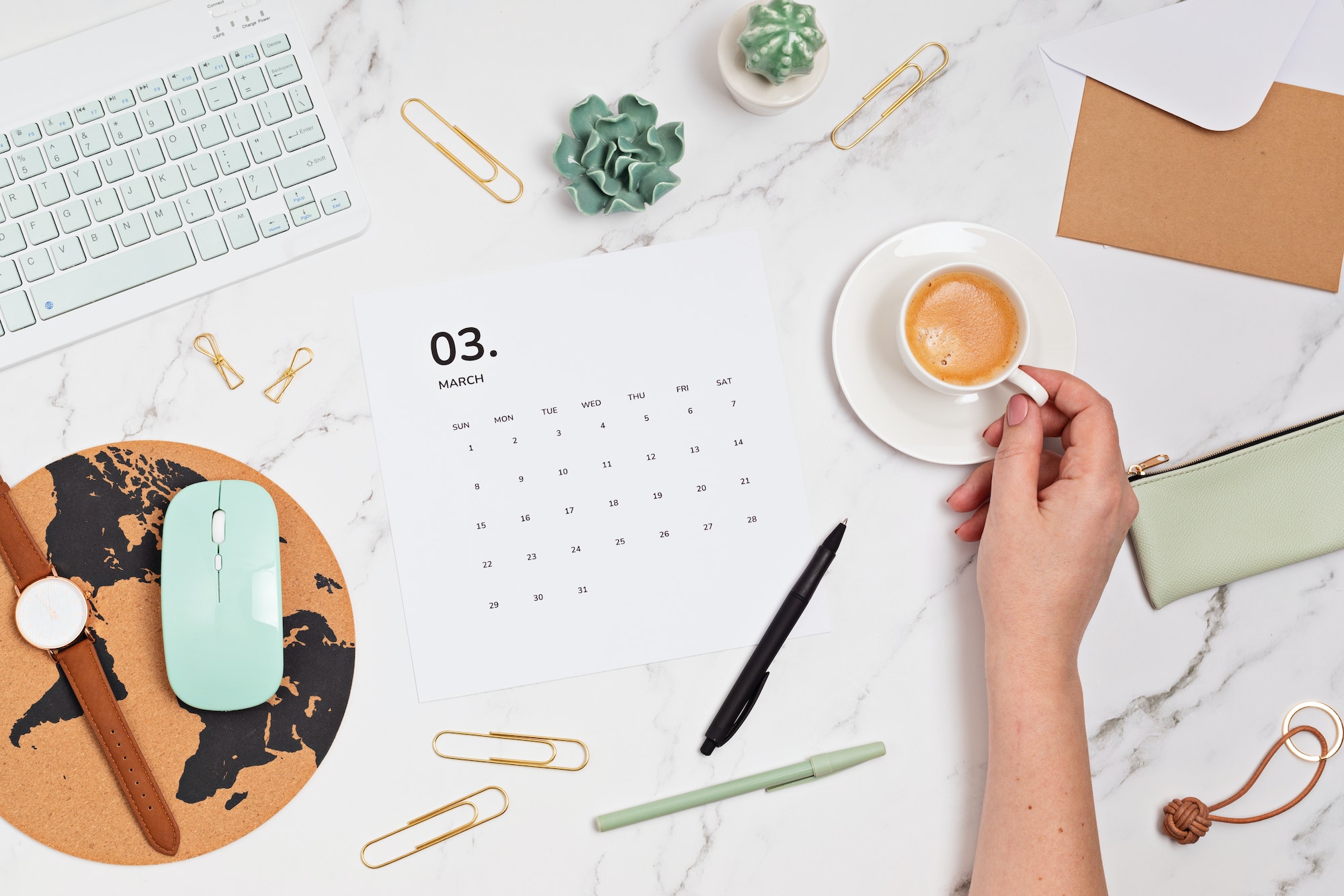 Desktop with calendar for march and office supplies